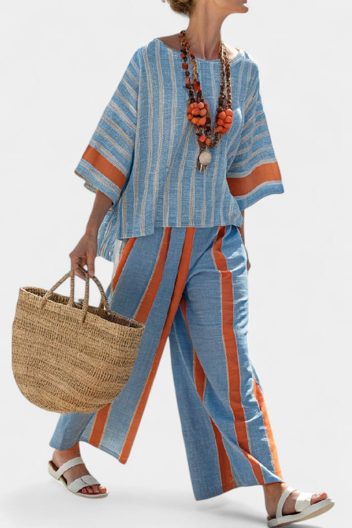 Close-up of the fringe hem detail on the striped linen top from the Calista two-piece set in blue and terracotta