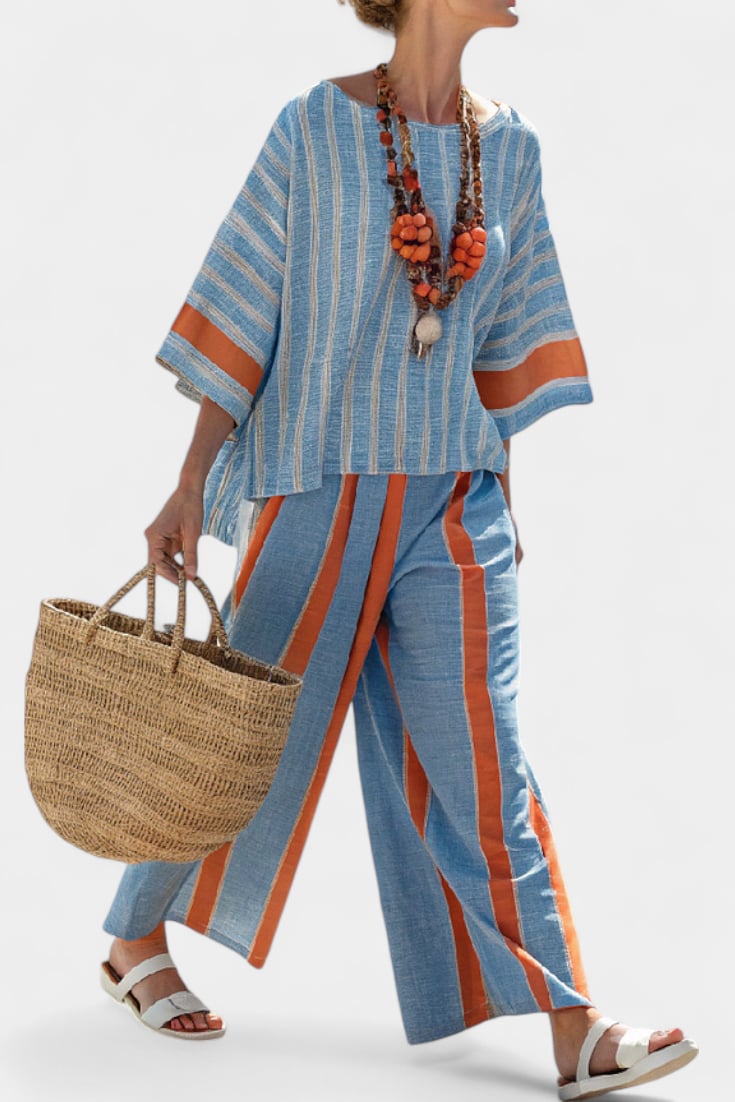 Close-up of the fringe hem detail on the striped linen top from the Calista two-piece set in blue and terracotta