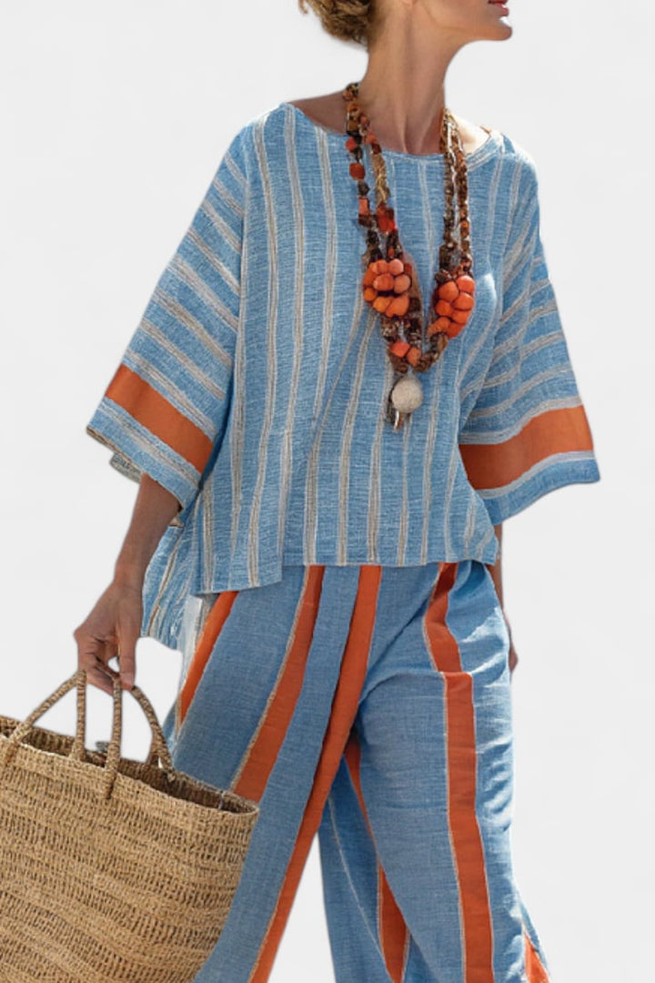 Side view of the Calista wide-leg striped linen pants showing the flowing silhouette and vertical stripe pattern