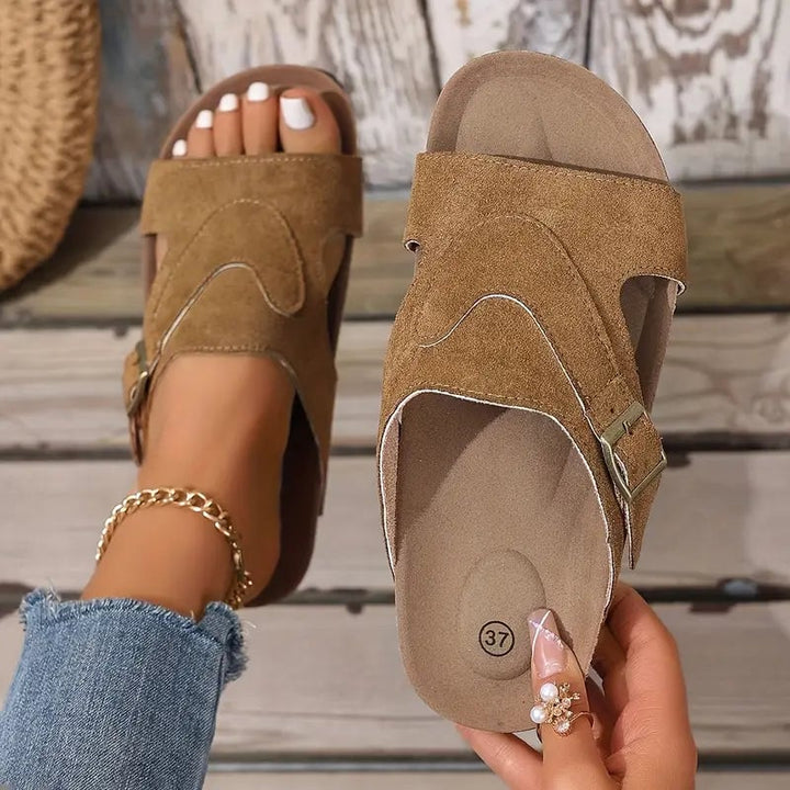 Calliope women's flat sandal in black, side profile highlighting contoured footbed