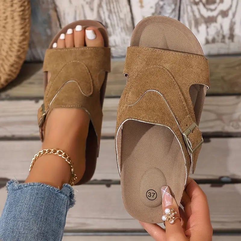 Calliope women's flat sandal in black, side profile highlighting contoured footbed