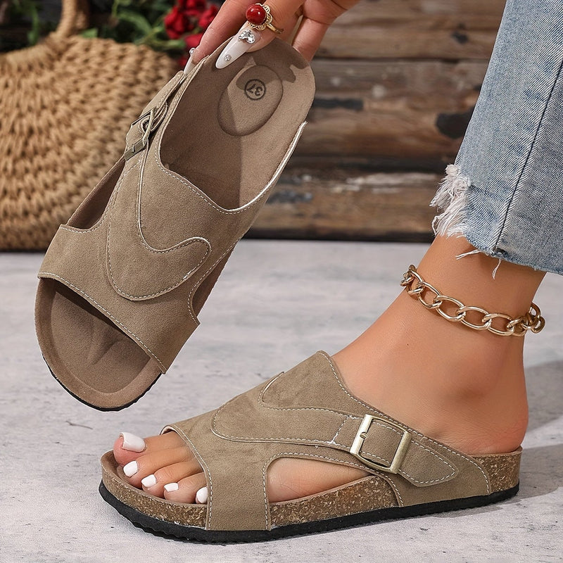 Calliope women's flat sandal in black, top-down view of strap and sole detail