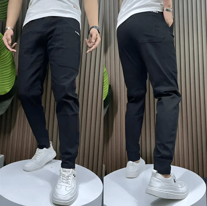 Front view of women's premium stretch cargo pants in a neutral color with side cargo pockets