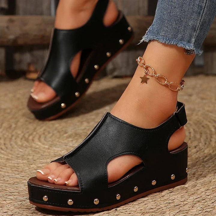 Camellia women's platform cushioned sandals in black, front three-quarter view showing elevated platform and sleek straps