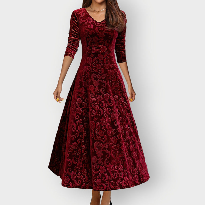 Woman wearing a rich red vintage velvet midi dress with a flattering curved silhouette, front view