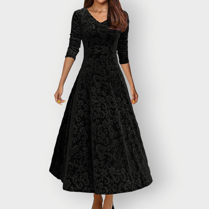 Woman wearing purple velvet midi dress, highlighting the midi length and tailored fit