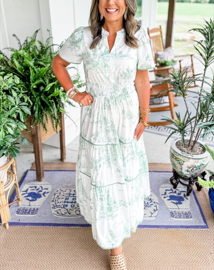 Model wearing the Camille Classic Toile Maxi Dress in blue styled for a garden occasion