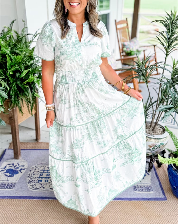Full-length shot of the Camille Classic Toile Maxi Dress in green on a model outdoors