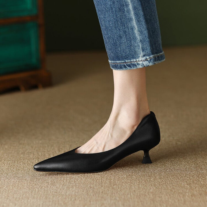 Camille black pump worn on foot, front three-quarter view on model