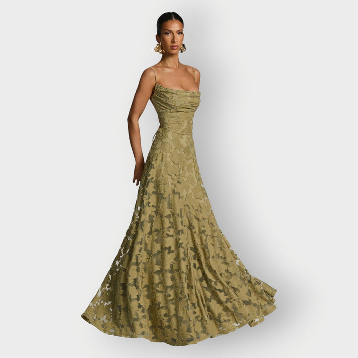 Model wearing an elegant strapless velvet gown in sage green showcasing the luxurious velvet fabric and neckline