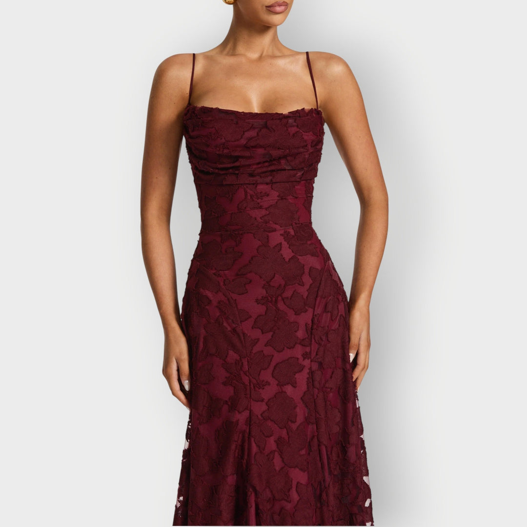 Side profile of the elegant strapless velvet gown in sage green showing the flowing skirt
