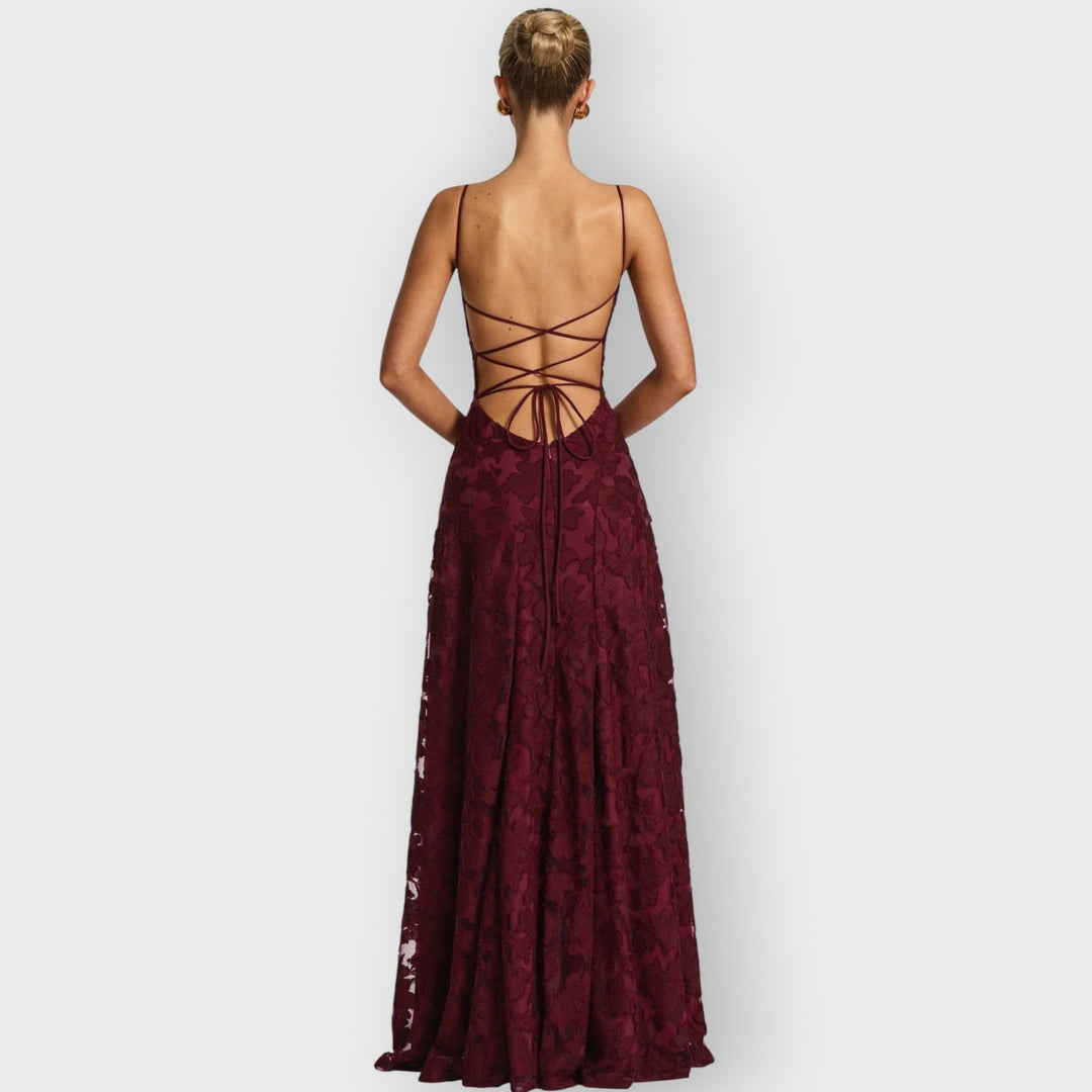Back view of the strapless velvet gown in cherry red displaying the clean structured back