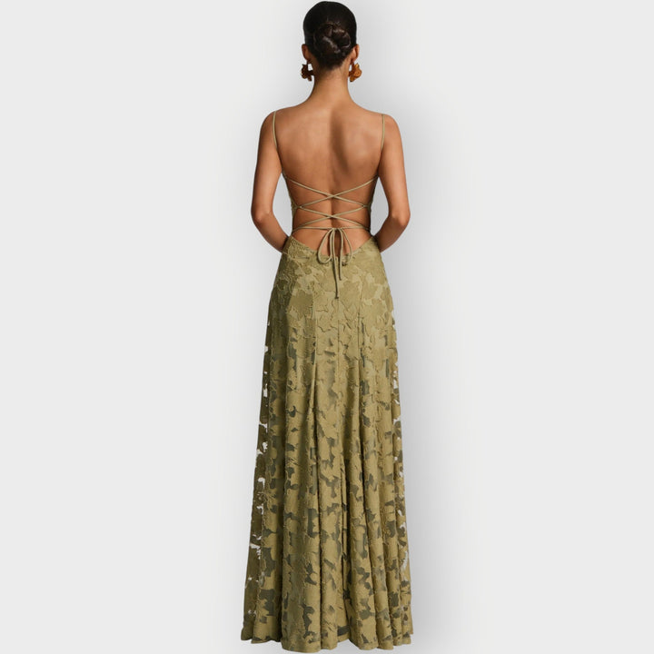 Model smiling in the strapless velvet gown in sage green at an evening event setting