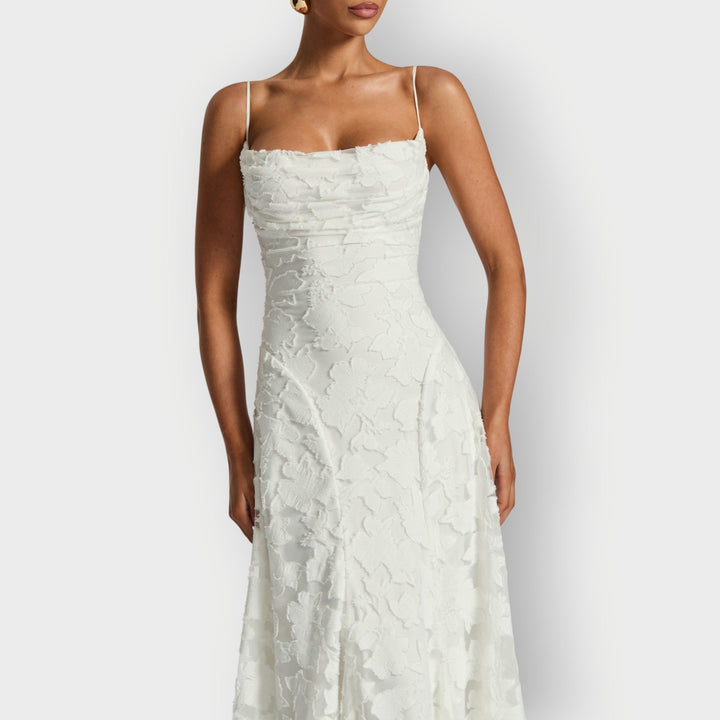 Three-quarter view of the ivory strapless velvet gown showing the flattering fit and flare