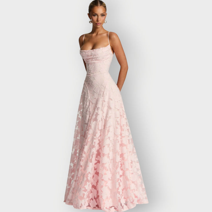 Full-length editorial shot of the strapless velvet gown in cherry red