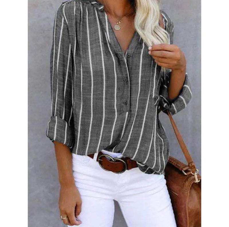 Close-up of red striped casual blouse showing button-tab sleeve detail and vertical stripe pattern