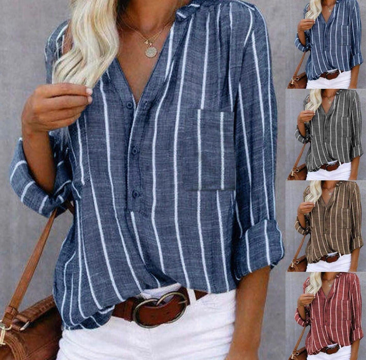 Detail shot of button-tab roll-up sleeve on striped casual blouse