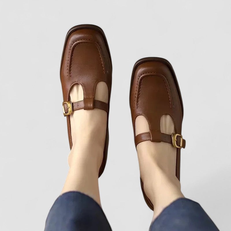 Brown orthopedic T-strap Mary Jane shoes with rounded toe and cushioned sole, shown from a front angle