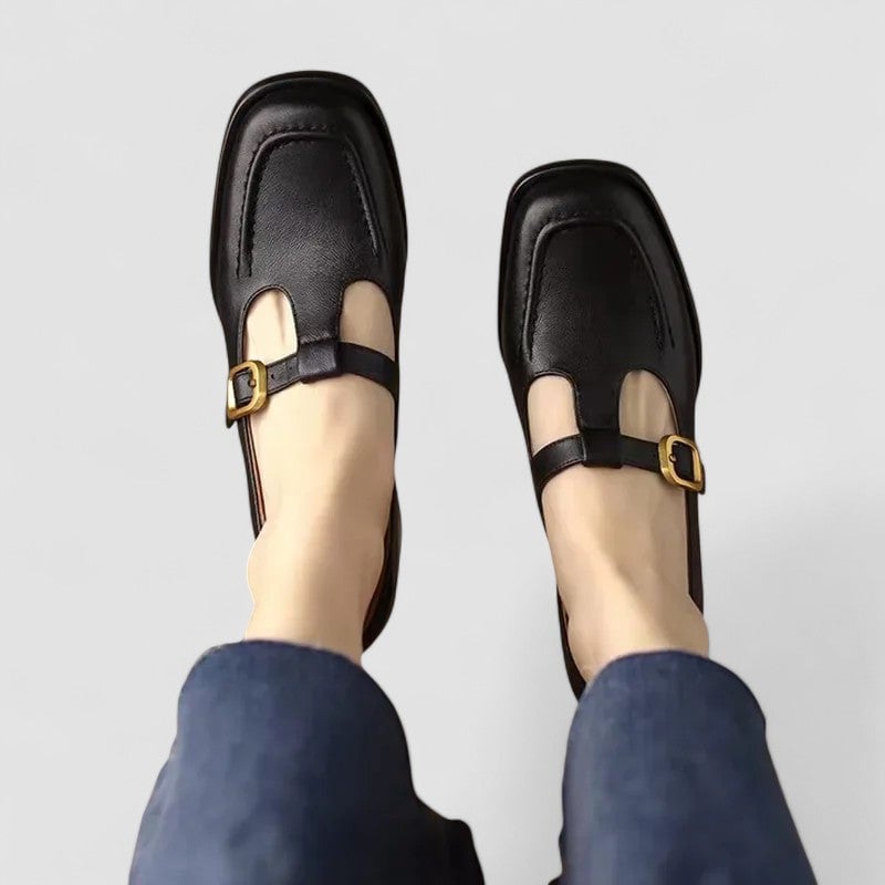 Black orthopedic T-strap Mary Jane shoes displayed on a clean white background, highlighting the T-strap detail