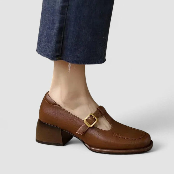 Close-up of the orthopedic sole and arch support on brown T-strap Mary Jane shoes