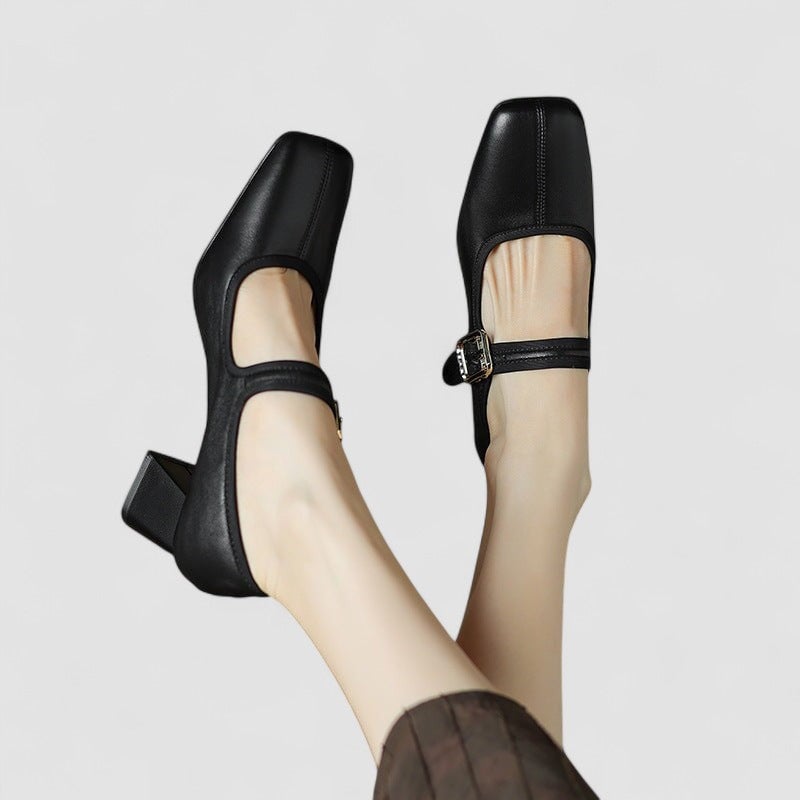 Pair of Cara orthopedic Mary Jane shoes in black, flat lay on neutral surface