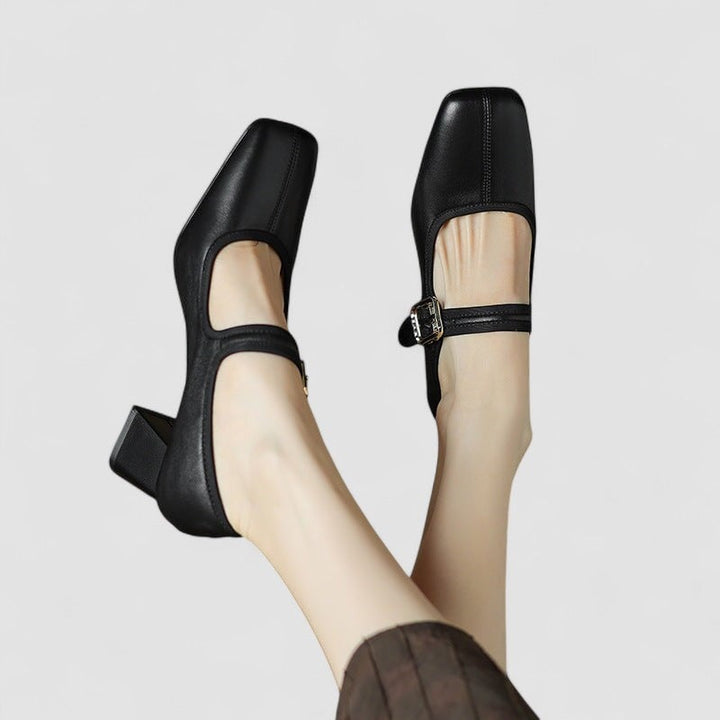 Pair of Cara orthopedic Mary Jane shoes in black, flat lay on neutral surface