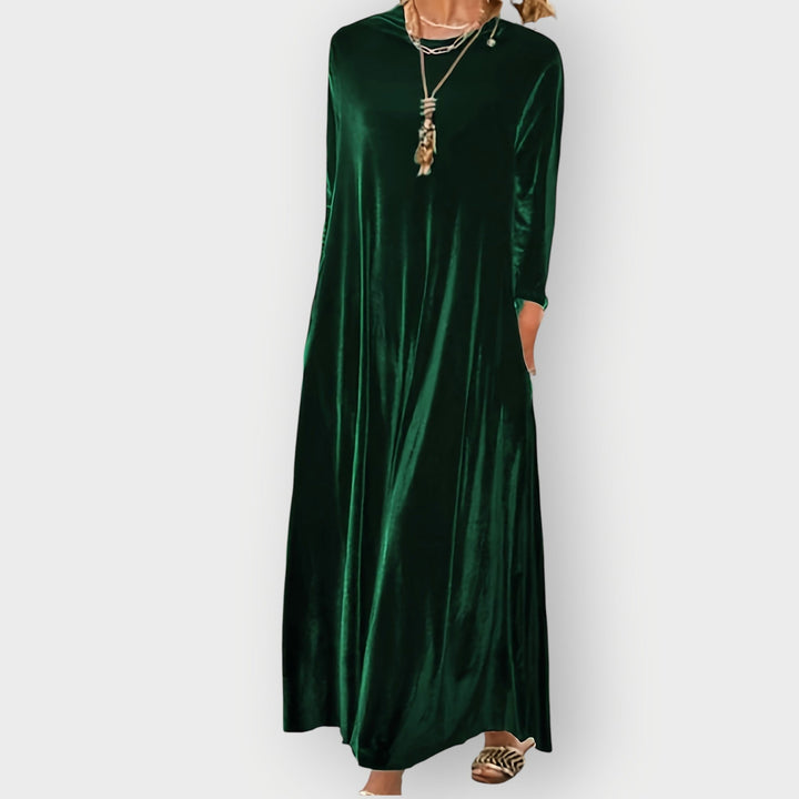 Close-up of soft plush velvet fabric on a flowing maxi dress showing rich texture and elegant sheen