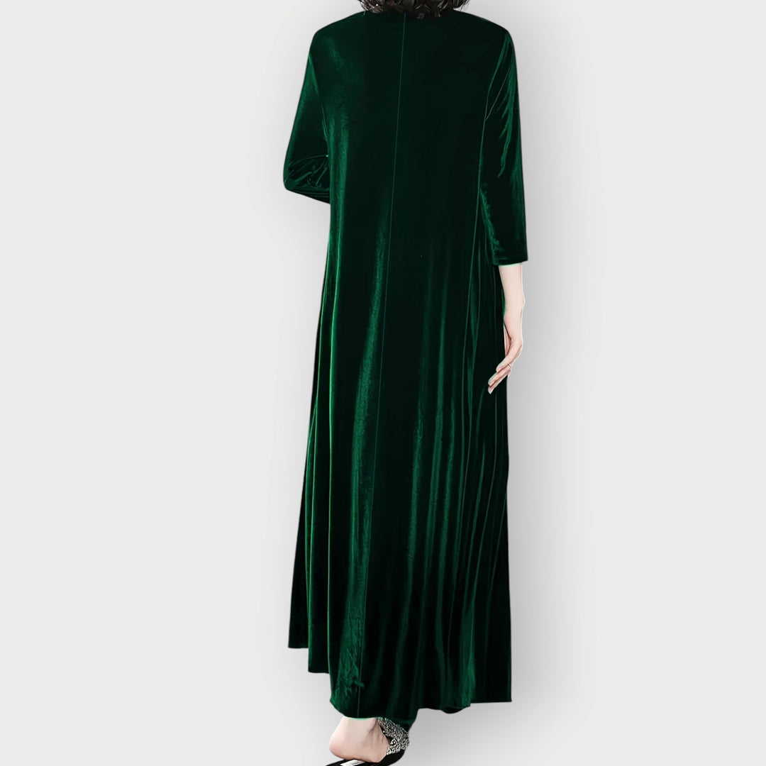 Full-length back view of model wearing a luxe velvet flow maxi dress in burgundy