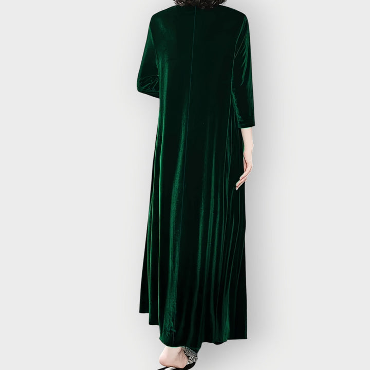 Full-length back view of model wearing a luxe velvet flow maxi dress in burgundy