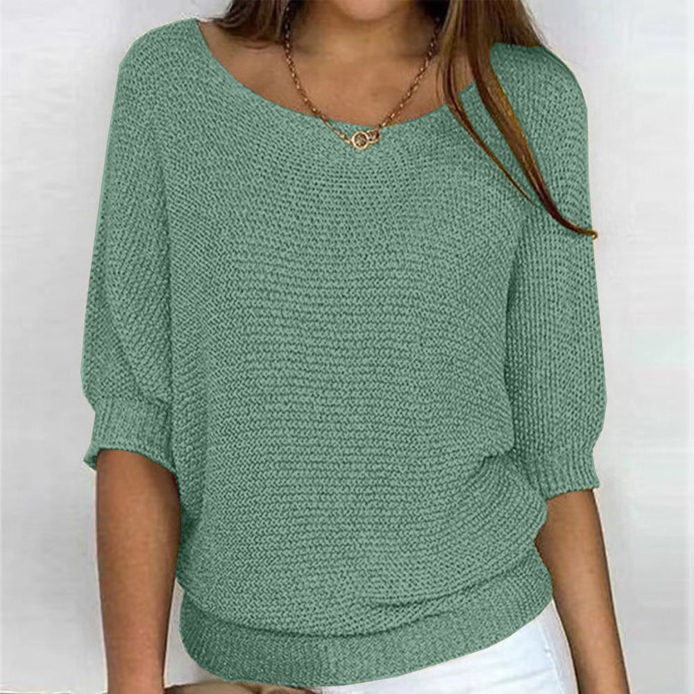 Carla comfort sweater laid flat showing its minimalist design and clean lines