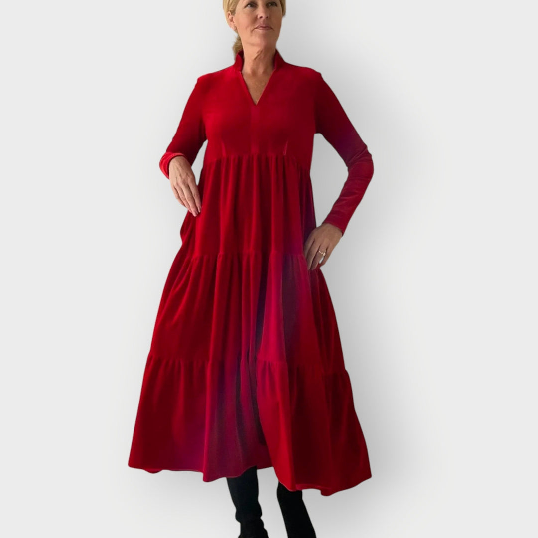 Front view of the Carmen red velvet dress showing its plush texture and tailored silhouette