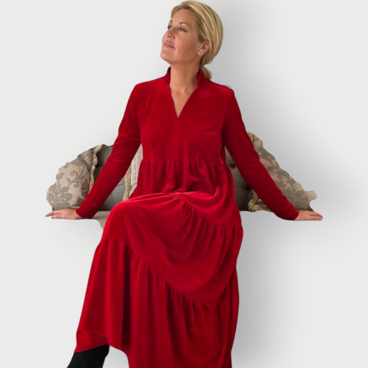 Full-length view of model wearing the Carmen red velvet dress styled for an evening occasion