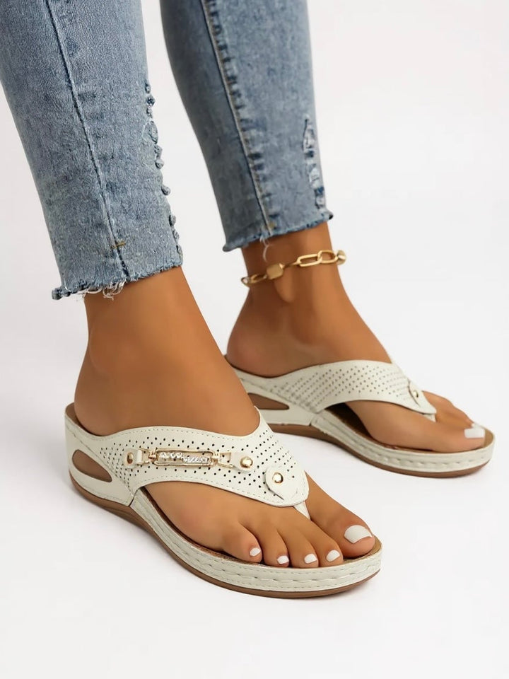Lifestyle flat lay of Carmen slip-on sandals styled with a flowy dress and straw tote