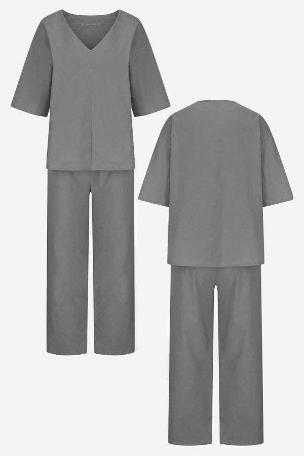 Flat lay of the Carmen two-piece set in red orange showing top and pants together