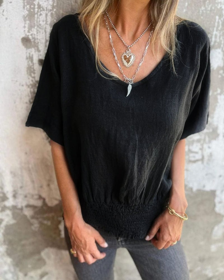 Model wearing the Carol relaxed summer top in apricot paired with casual bottoms