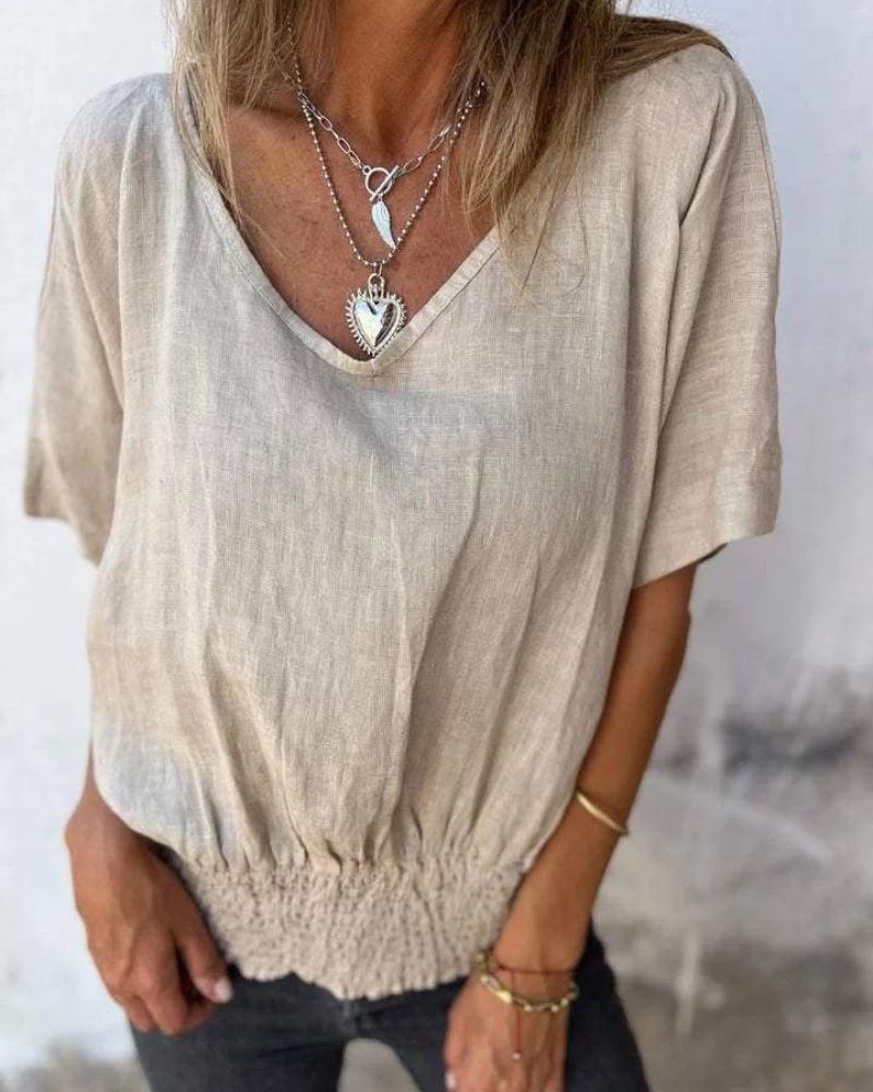 Flat lay of the Carol relaxed summer top in multiple color options including brown, white, apricot, and black