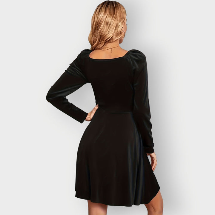 Flat lay of a velvet skater dress in all three colorways – red, green, and black