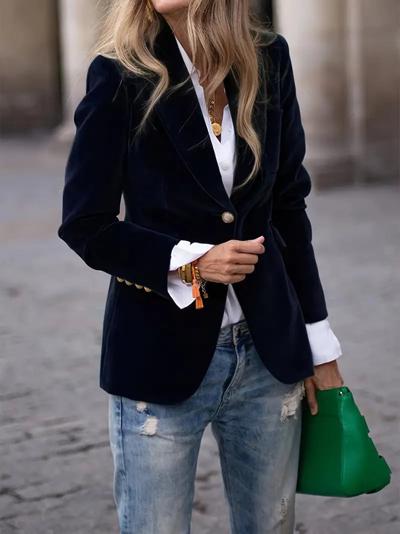 Woman wearing an elegant black velvet blazer with a smooth, flattering silhouette