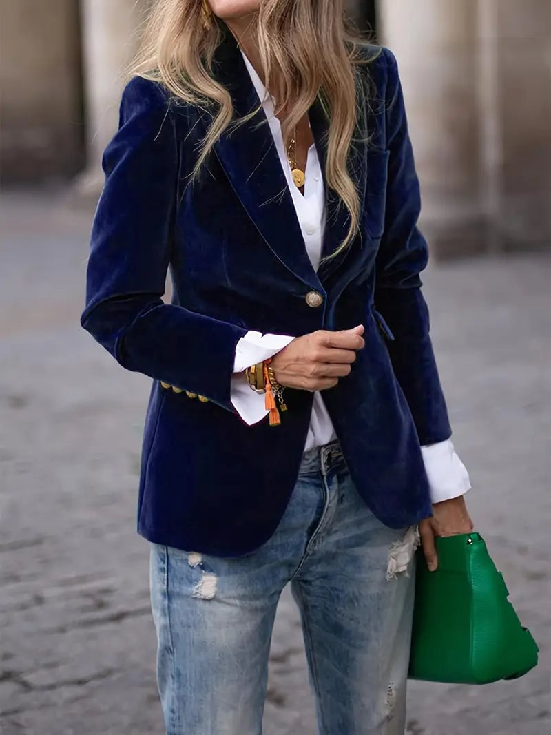 Front view of a rich blue velvet blazer with subtle sheen on a female model