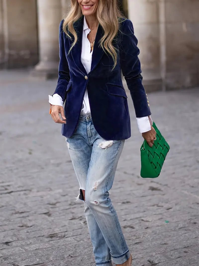 Model wearing a green velvet blazer in a casual weekend style with jeans