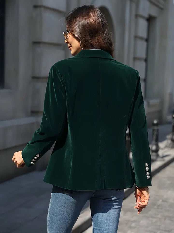 Back view of a red velvet blazer showing clean tailoring and smooth drape