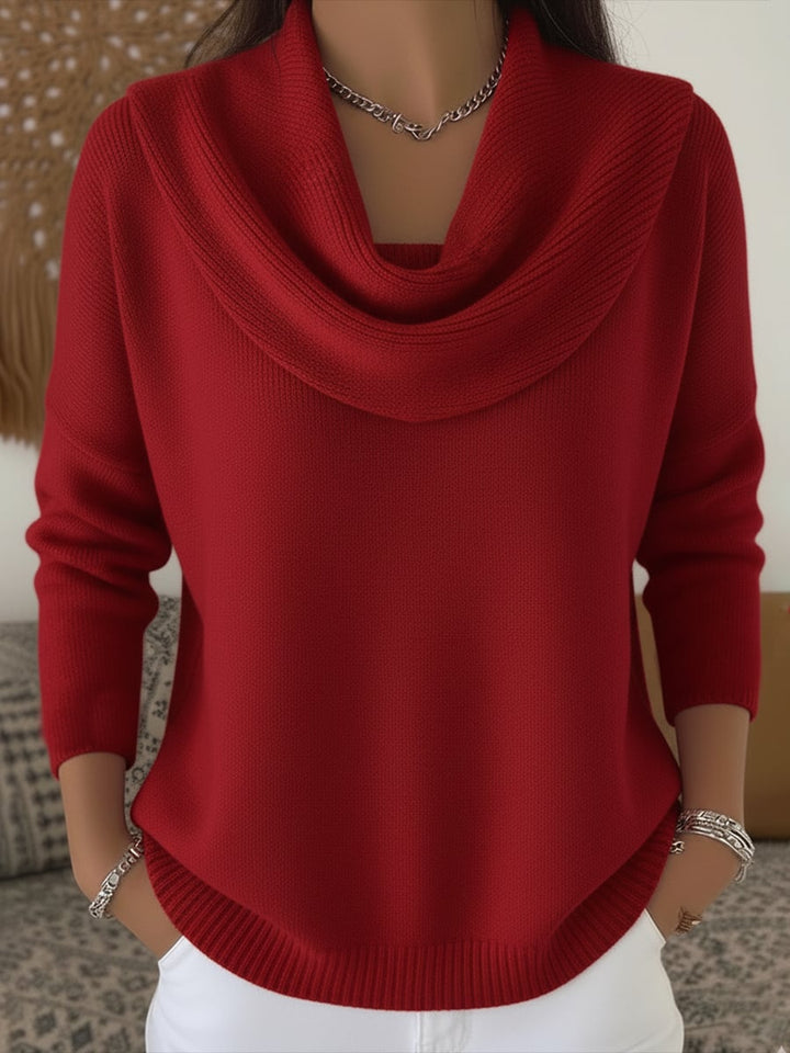Woman wearing a red cowl collar sweater with a relaxed fit, front view