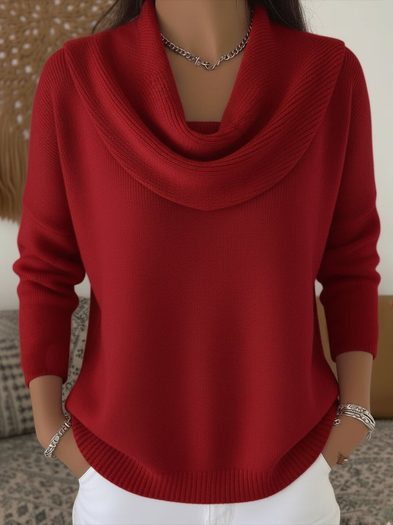 Woman wearing a red cowl collar sweater with a relaxed fit, front view