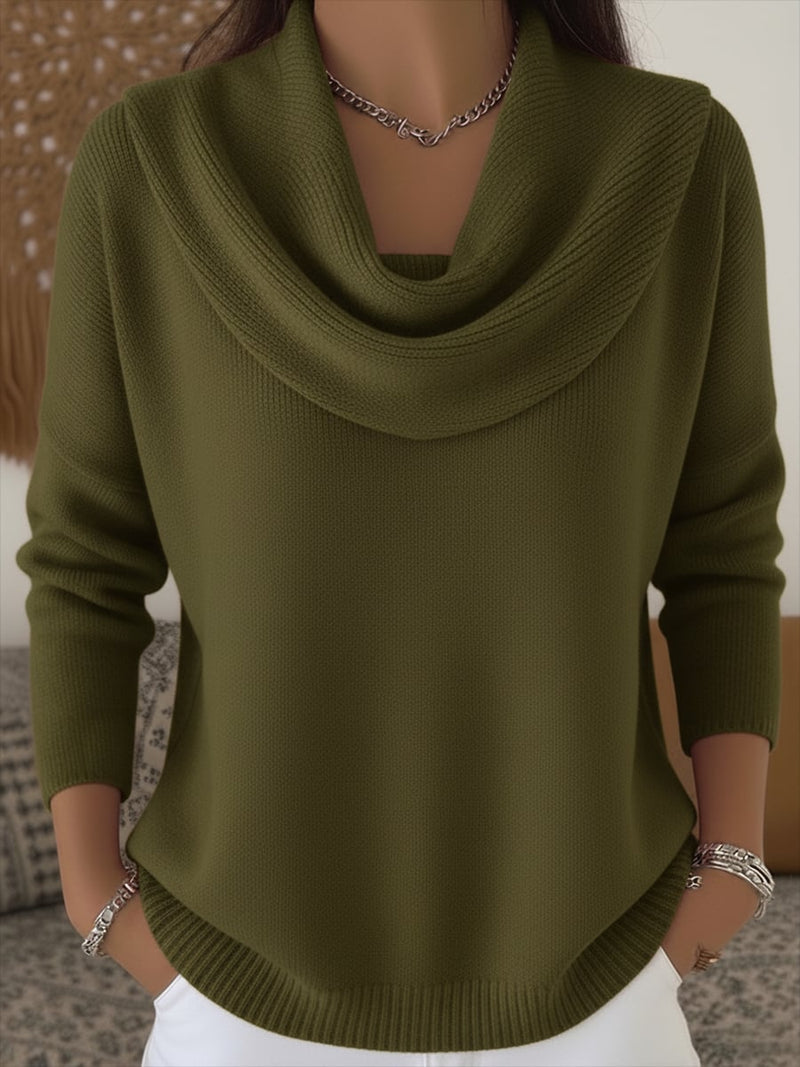 Woman styled in a green cowl collar sweater paired with trousers, full-length view