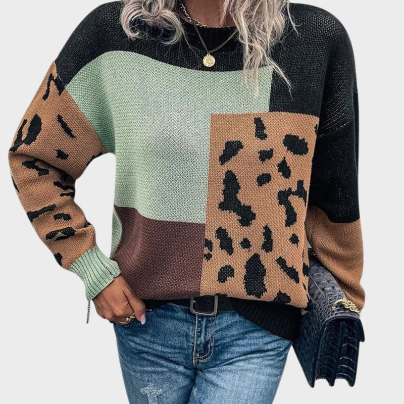 Woman wearing the Caroline relaxed-fit sweater in black, styled with jeans for a casual everyday look