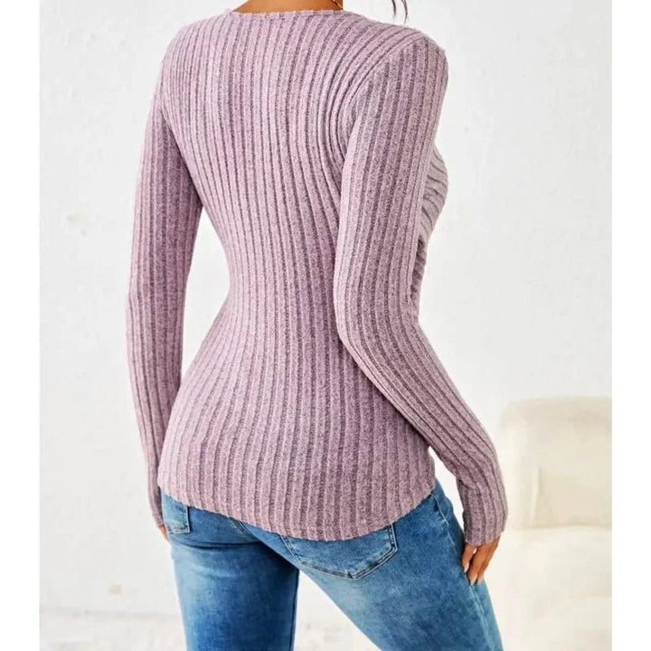 Woman layering the tummy-tucking long sleeve top under a blazer for a polished casual look