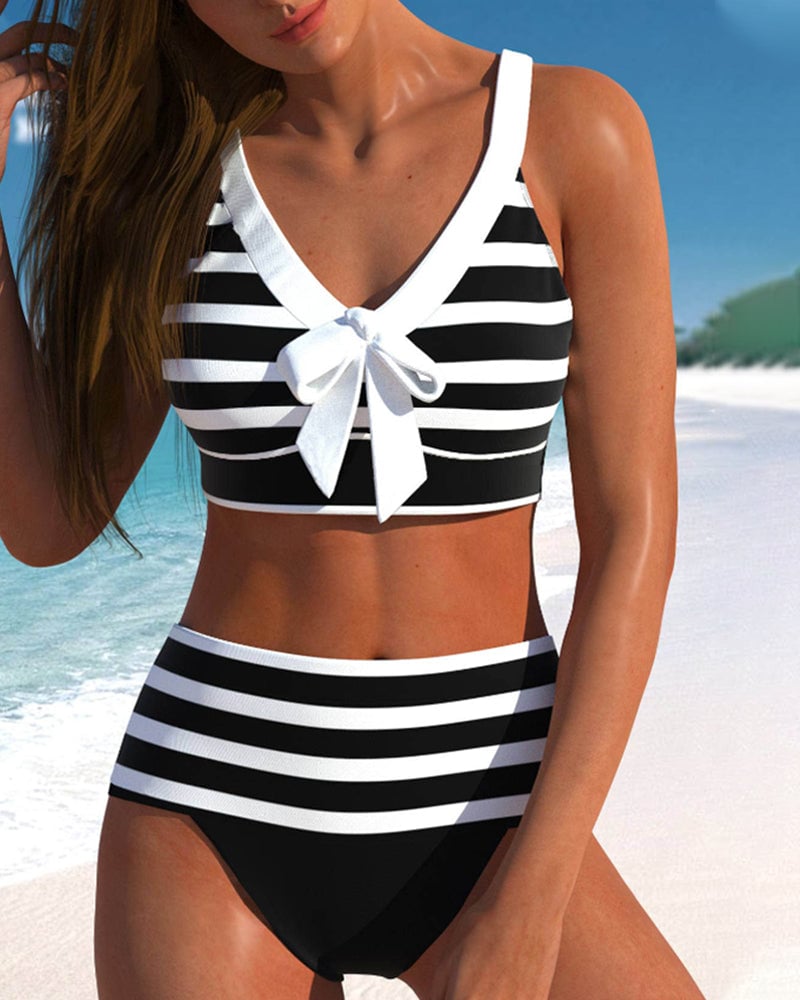 Front view of Caroline high waist striped bikini set in black on a model at the beach
