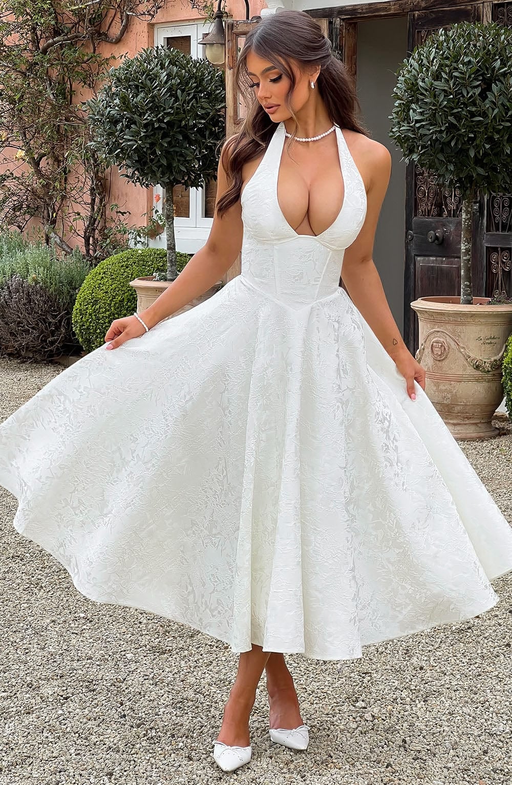 Full-length view of the Caroline dress in white showing lightweight flowing fabric