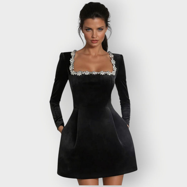Woman wearing a red velvet square-neck mini dress with a tailored fit and elegant neckline
