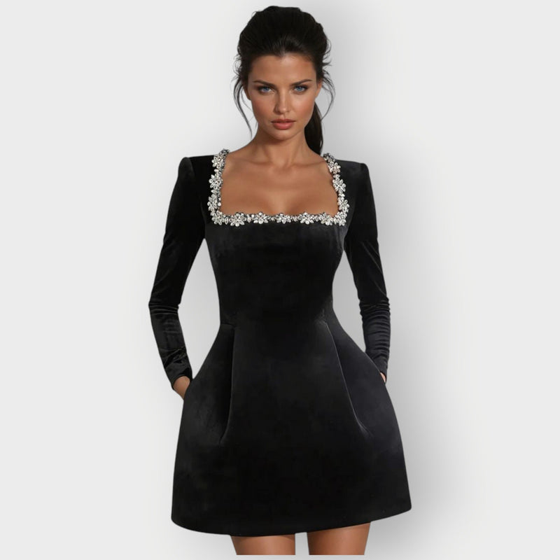 Woman wearing a red velvet square-neck mini dress with a tailored fit and elegant neckline